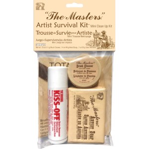 The image shows "The Masters®" Artist Survival Kit, which includes a Kiss-Off® stain remover stick, a Fresh Cleanser, a bar of Original Formula artist soap, and an absorbent cloth. The items are packaged in clear plastic with a brown paper header card.