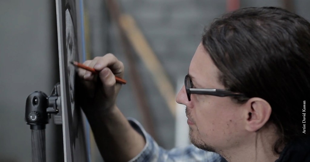 Artist David Kassan is drawing a portrait with a Charcoal Pencil.