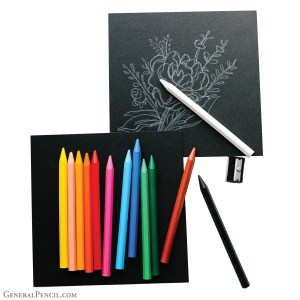 Top of image: Black square paper with a drawing of a flower in white. White PlastiPastel® Crayon on top of the paper and drawing. Below: Black square paper overlapping the bottom left corner of the drawing above with 11 PlastiPastel® Crayons on it in yellow, peach, marigold, orange, red, pink, light blue, dark blue, light green, dark green, and brown. A black PlastiPastel® crayon is off to the side with a black sharpener above it.