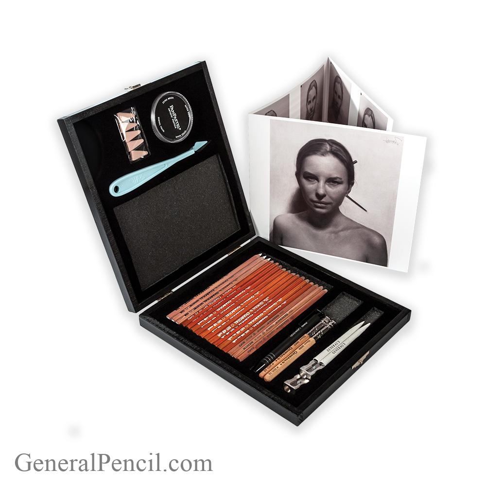 A set of art supplies including pencils, a sharpener, an eraser, and a blending tool are neatly arranged in an open black case. The case also contains a monochrome photo of a woman, and the brand name "David Jon Kassan" with a signature is displayed above.
